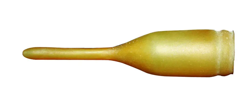 A gold colored bottle with a long handle.