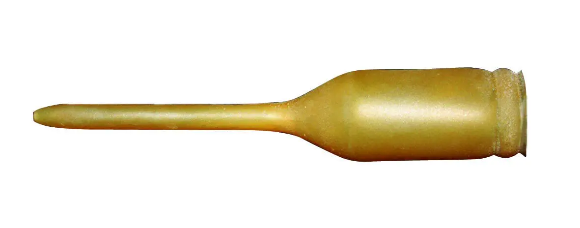 A gold colored bottle with a long handle.