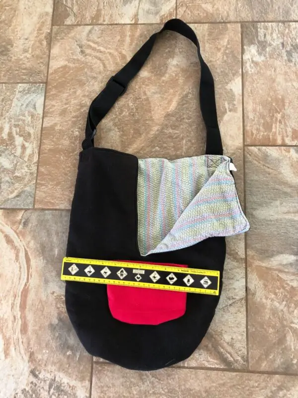 A black bag with yellow and red accents on it.