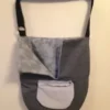 A gray bag hanging on the wall