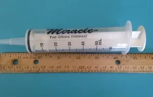 A measuring tape and ruler are next to each other.