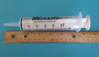 A measuring tape and ruler are next to each other.