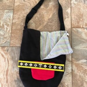 A black bag with yellow and red accents on it.